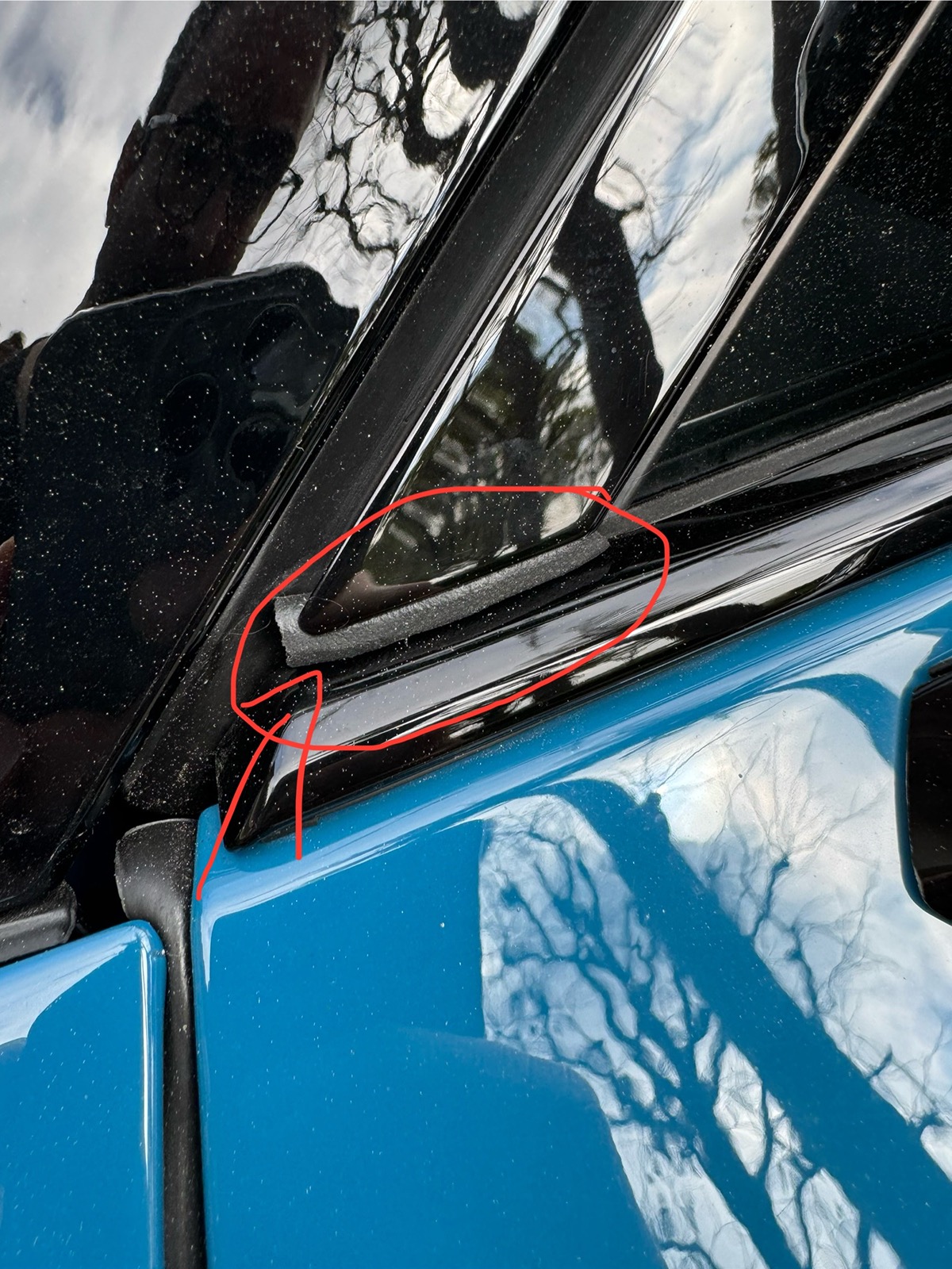 Rivian R1T R1S Resolved (my) excessive wind noise 2023 R1T (cause: corner window plastic trim) IMG_1557